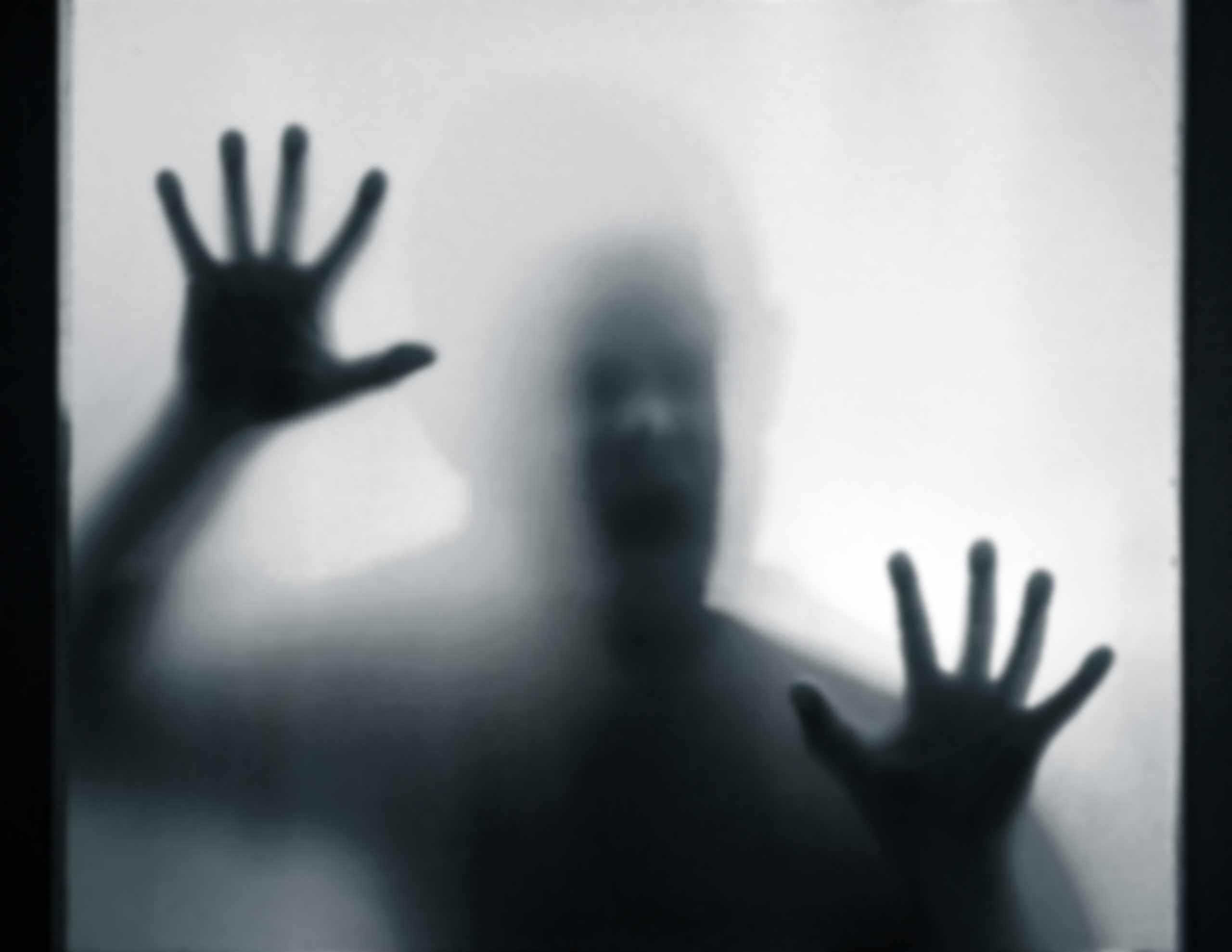 Shadowy figure behind glass – horror background